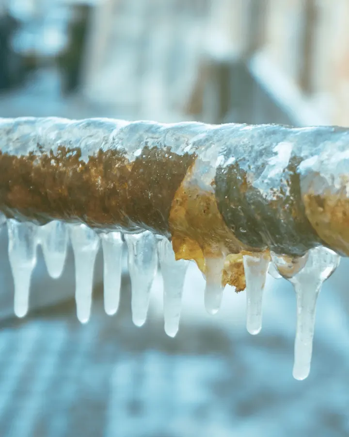 Monroe frozen pipe water damage: an ice-coated pipe with icicles after a hard freeze